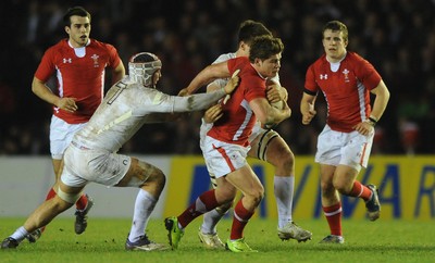 240212 - England Under 20 v Wales Under 20 - Under 20 Six Nations -Harry Robinson of Wales is tackled by Chris Walker of England