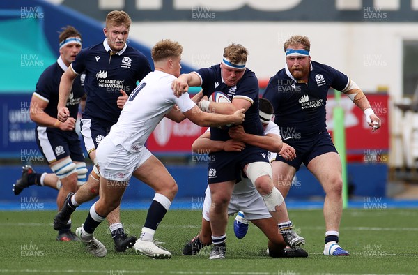 250621 - England U20s v Scotland U20s - U20s 6 Nations Championship - Patrick Harrison of Scotland is tackled by Fin Smith and Lucas Brooke of England