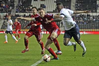 050314 - England U'21's vs Wales U'21's -EUFA U'21's Qualifying Group One-Scott Tancock of Wales sees off the threat of Saido Berahino of England(c) Huw Evans Agency