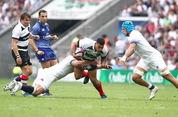 270518 - England v Barbarians - Quilter Cup - Josh Matavesi of Barbarians is tackled by Jack Singleton(L) and Zach Mercer of England
