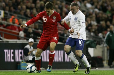 06.09.11 -  England v Wales -UEFA Euro 2012 Qualifier Group G ....  Wales's Captain Aaron Ramsey is put under pressure from England Wayne Rooney. 