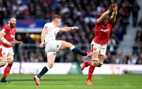 070320 - England v Wales - Guinness Six Nations - Owen Farrell of England kicks past Alun Wyn Jones of Wales