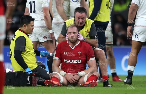 070320 - England v Wales - Guinness 6 Nations Championship - A dejected Alun Wyn Jones of Wales is looked at by medical staff