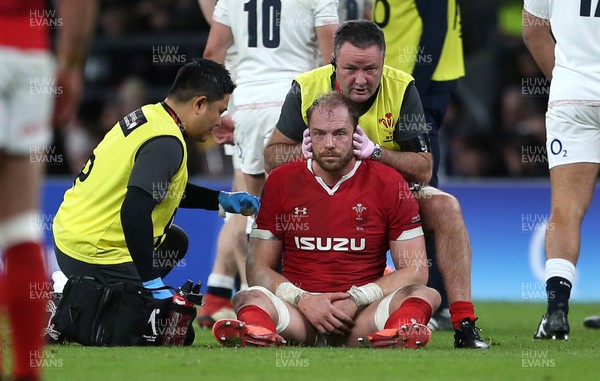 070320 - England v Wales - Guinness 6 Nations Championship - A dejected Alun Wyn Jones of Wales is looked at by medical staff