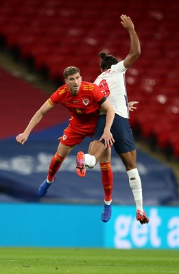 081020 - England v Wales - International Friendly -  Chris Mepham of Wales and Dominic Calvert-Lewin of England compete in the air