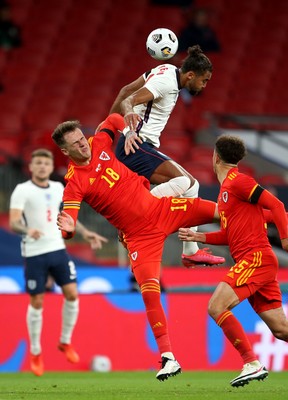 081020 - England v Wales - International Friendly -  Joe Rodon of Wales and Dominic Calvert-Lewin of England compete in the air