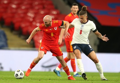 081020 - England v Wales - International Friendly -  Jonny Williams of Wales is tackled by Kalvin Phillips of England