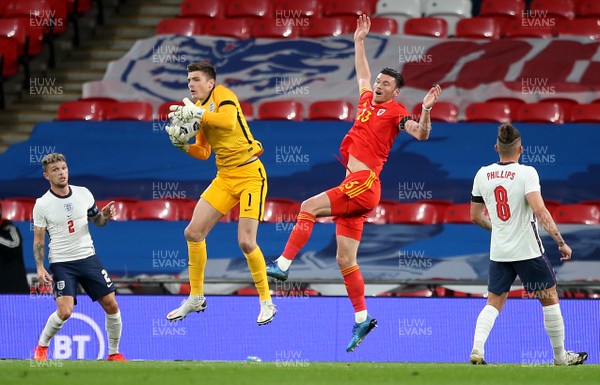 081020 - England v Wales - International Friendly -  Nick Pope of England gathers ball as Kieffer Moore of Wales competes in the air