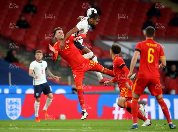 081020 - England v Wales - International Friendly -  Joe Rodon of Wales and Dominic Calvert-Lewin of England compete in the air