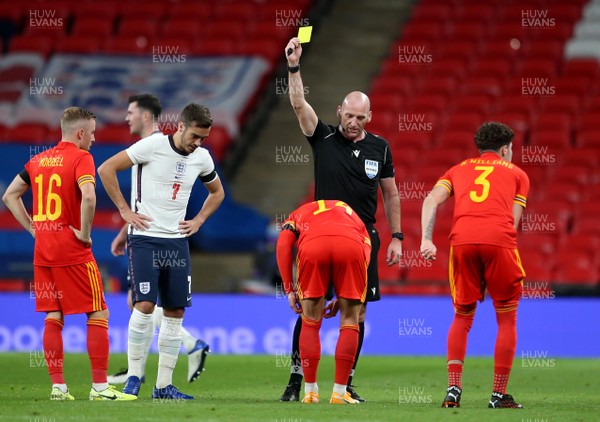 081020 - England v Wales - International Friendly -  Connor Roberts of Wales is shown a yellow card