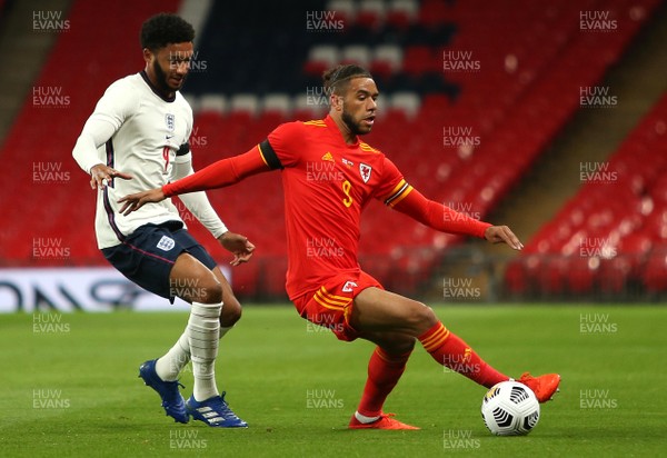 081020 - England v Wales - International Friendly -  Tyler Roberts of Wales is challenged by Joe Gomez of England