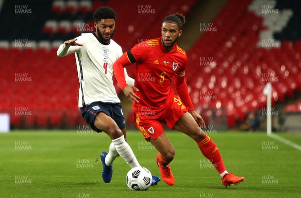 081020 - England v Wales - International Friendly -  Tyler Roberts of Wales is challenged by Joe Gomez of England