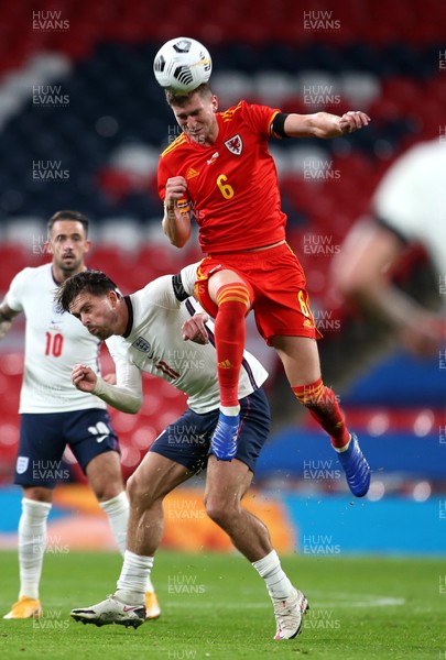 081020 - England v Wales - International Friendly -  Chris Mepham of Wales gets above Jack Grealish of England