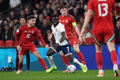 091025 - England v Wales - International Friendly - Bukayo Saka of England is challenged by Liam Cullen of Wales