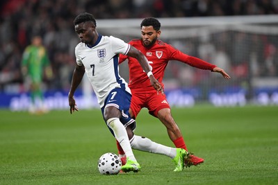 091025 - England v Wales - International Friendly - Bukayo Saka of England is challenged by Jay Dasilva of Wales