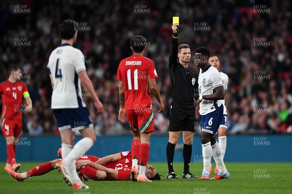 091025 - England v Wales - International Friendly - Mark Guehi of England is shown a yellow card after a foul on Kieffer Moore of Wales