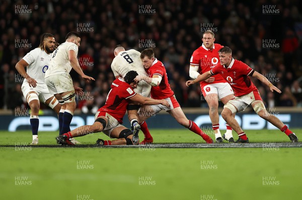100224 - England v Wales - Guinness 6 Nations - Dafydd Jenkins and Nick Tompkins of Wales tackle Ben Earl of England 