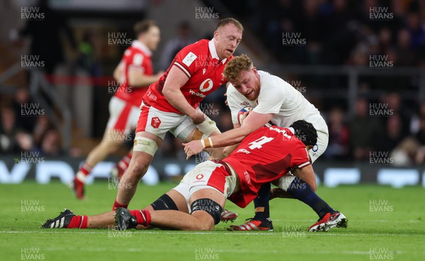 100224 - England v Wales, Guinness 6 Nations 2024 - Ollie Chessum of England is tackled by Dafydd Jenkins of Wales and Tommy Reffell of Wales