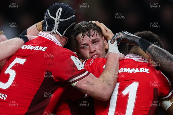100224 - England v Wales, Guinness 6 Nations 2024 - Alex Mann of Wales is congratulated by team mates after scoring try