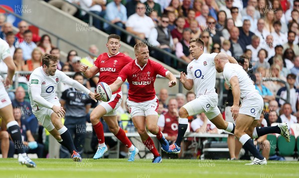 110819 - England v Wales - World Cup Warm Up - Quilter International - Gareth Anscombe of Wales is tackled by Willi Heinz of England