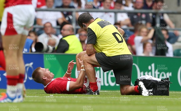110819 - England v Wales - World Cup Warm Up - Quilter International - Gareth Anscombe of Wales is looked at by medics