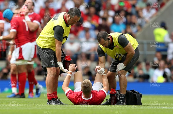110819 - England v Wales - World Cup Warm Up - Quilter International - Gareth Anscombe of Wales is taken off the field injured, helped by medics