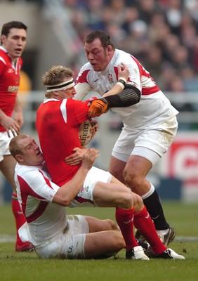 04.02.06  England  v Wales  Wales matthew Watkins is tackled by Mike Tindall and Steve Thompson.  