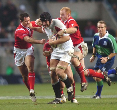 04.02.06  England  v Wales  Steve Borthwick hands off Gareth Cooper while Martyn Williams hitches a ride.  