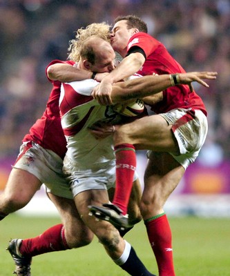 04.02.06  England  v Wales  Lawrence Dallaglio is tackled by Duncan Jones and Mark Jones.  