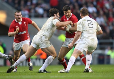 250212 - England v Wales, RBS 6 Nations - Wales' Mike Phillips is held by England's Alex Corbisiero and England's Dylan Hartley 