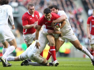 250212 England v WalesWales' Mike Phillips is tackled by England's Alex Corbisiero and England's Tom Croft