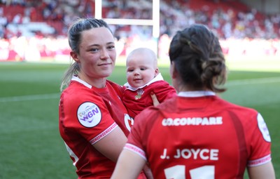 250426 - England v Wales, 2026 Guinness Women’s 6 Nations - Alisha Joyce of Wales and Jasmine Joyce of Wales with Ralphie at the end of the match