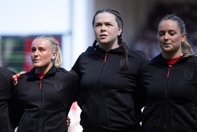 250426 - England v Wales, 2026 Guinness Women’s 6 Nations - Seren Singleton of Wales, Maisie Davies of Wales and Freya Bell of Wales line up for the anthems ahead of the match