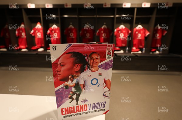 250426 - England v Wales, 2026 Guinness Women’s 6 Nations - A match programme with Wales match jerseys hanging in the changing room ahead of the match