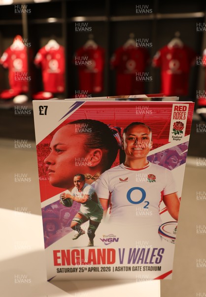 250426 - England v Wales, 2026 Guinness Women’s 6 Nations - A match programme with Wales match jerseys hanging in the changing room ahead of the match