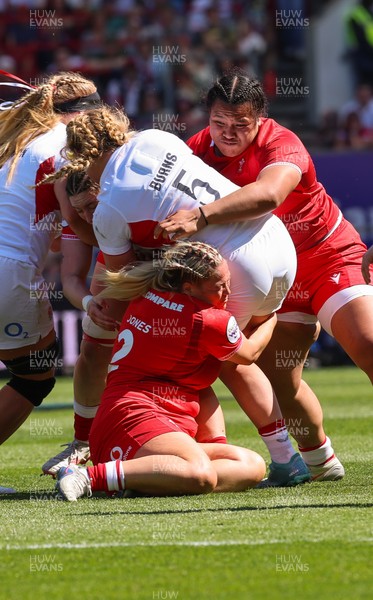 250426 - England v Wales, 2026 Guinness Women’s 6 Nations - Delaney Burns of England is tackled by Kelsey Jones of Wales and Sisilia Tuipulotu of Wales
