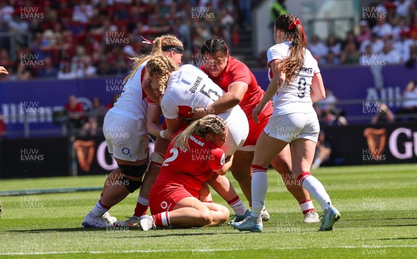 250426 - England v Wales, 2026 Guinness Women’s 6 Nations - Delaney Burns of England is tackled by Kelsey Jones of Wales and Sisilia Tuipulotu of Wales