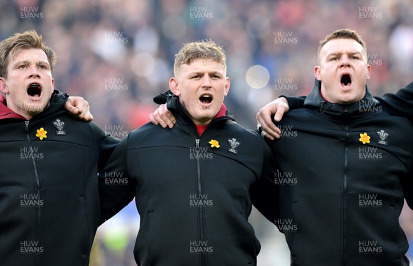 260222 - England v Wales - Guinness Six Nations 2022 - Nick Tompkins, Jac Morgan and Dewi Lake of Wales during the anthems
