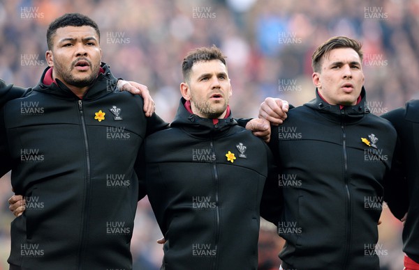 260222 - England v Wales - Guinness Six Nations 2022 - Leon Brown, Tomos Williams and Taine Basham of Wales during the anthems
