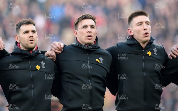 260222 - England v Wales - Guinness Six Nations 2022 - Tomos Williams, Taine Basham, Josh Adams of Wales during the anthems