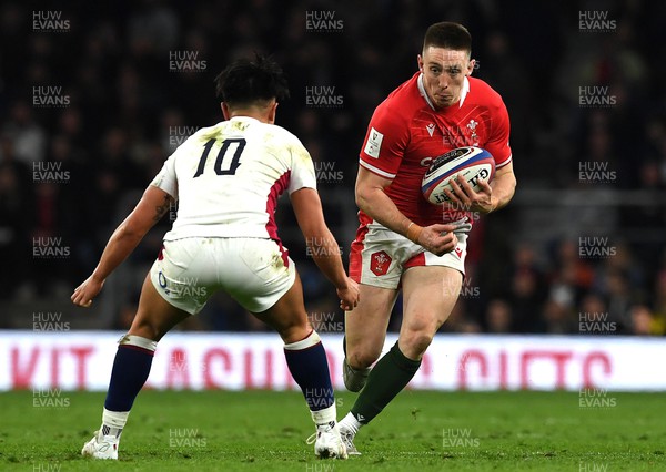 260222 - England v Wales - Guinness Six Nations 2022 - Josh Adams of Wales is tackled by Marcus Smith of England