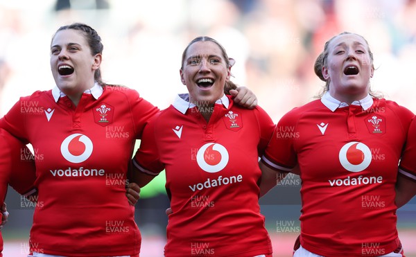 300324 - England v Wales, Guinness Women’s 6 Nations - Natalia John of Wales, Georgia Evans of Wales and Abbie Fleming of Wales during the anthem