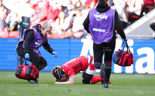 300324 - England v Wales, Guinness Women’s 6 Nations - Jo Perkins, medic and Dr Gwennan Williams treat Bethan Lewis of Wales 