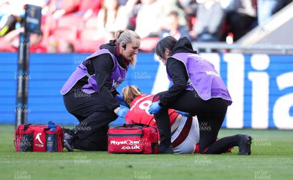 300324 - England v Wales, Guinness Women’s 6 Nations - Jo Perkins, medic and Dr Gwennan Williams treat Bethan Lewis of Wales 