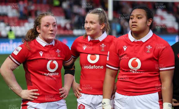 300324 - England v Wales, Guinness Women’s 6 Nations - Kate Williams of Wales, Carys Cox of Wales and Sisilia Tuipulotu of Wales at the end of the match