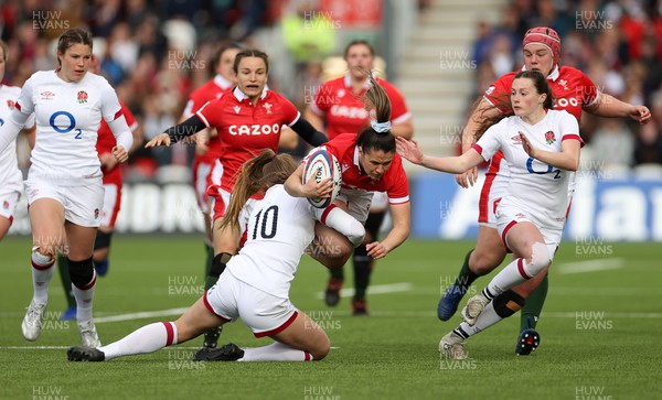 090422 - England Women v Wales Women - TikTok Womens Six Nations - Kayleigh Powell of Wales is tackled by Zoe Harrison of England