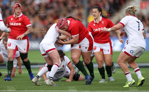 090422 - England Women v Wales Women - TikTok Womens Six Nations - Carys Phillips of Wales is tackled by Lucy Packer of England