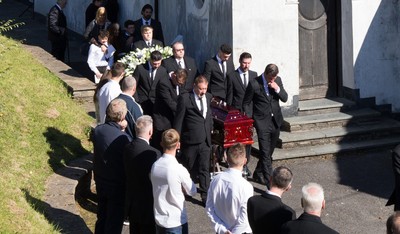 280918 - Enzo Calzaghe Funeral, Newbridge, South Wales - Former World Champion boxer Joe Calzaghe, right, leads the coffin out of the church at the funeral of his father and boxing trainer Enzo Calzaghe