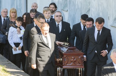 280918 - Enzo Calzaghe Funeral, Newbridge, South Wales - Former World Champion boxer Joe Calzaghe, right, leads the coffin out of the church at the funeral of his father and boxing trainer Enzo Calzaghe