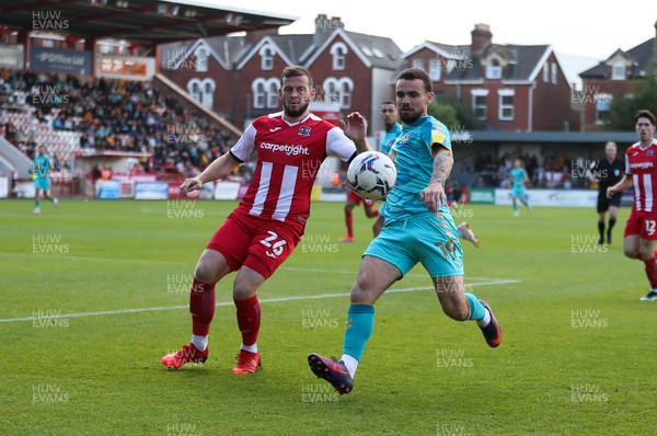 161021 - Exeter City v Newport County, EFL Sky Bet League 2 - Dom Telford of Newport County plays the ball as Pierce Sweeney of Exeter City closes in 